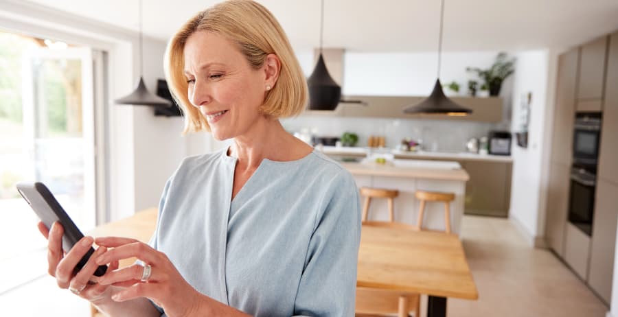 Woman with cell phone in a modern home